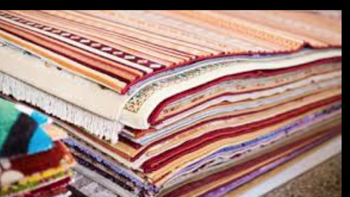 Rugs stacked inside a showroom with limited online visibility